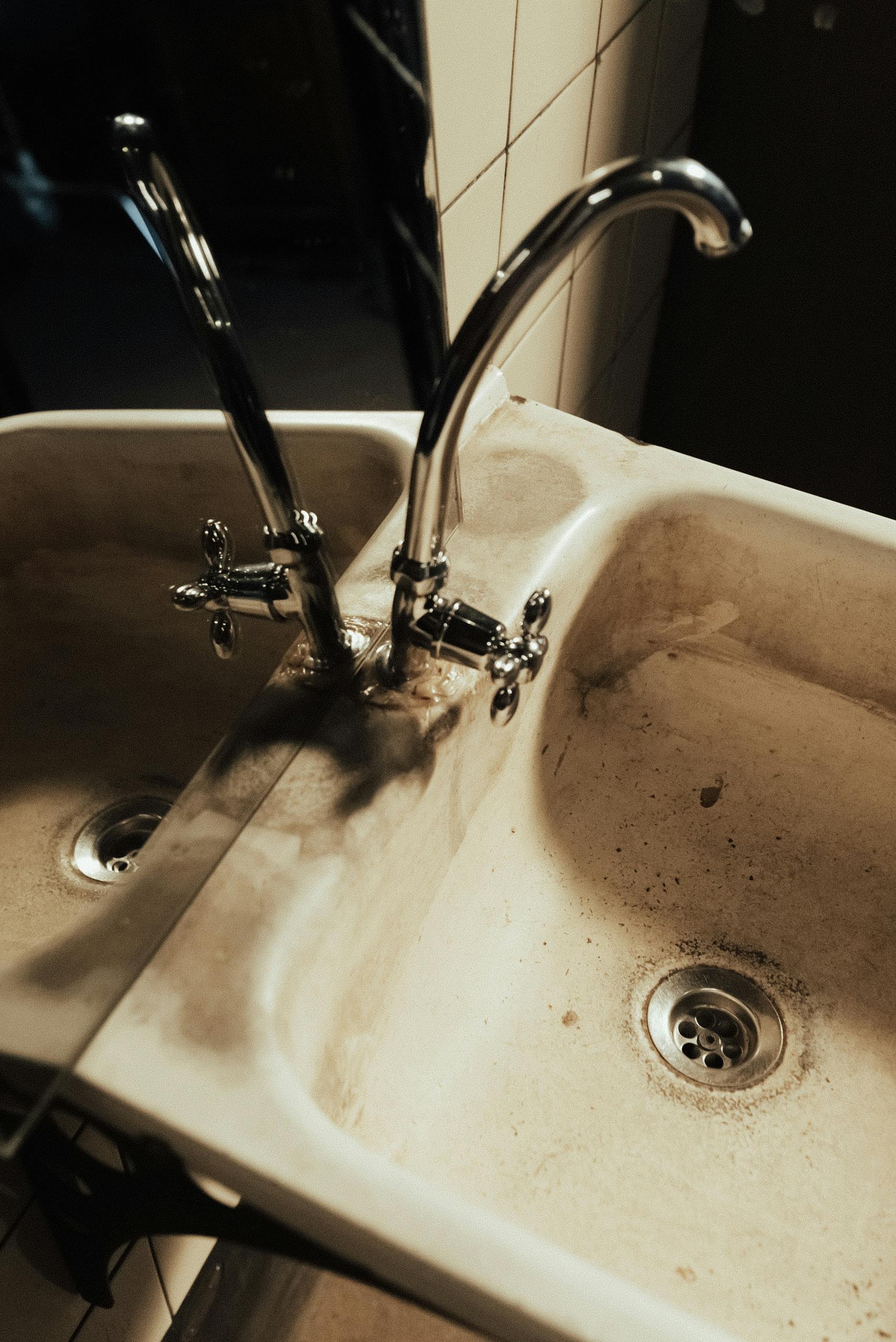 Old Home A Neglected Bathroom Sink With Visible Dirt And A Faucet Reflection In The Mirror 10473680 Scaled 1